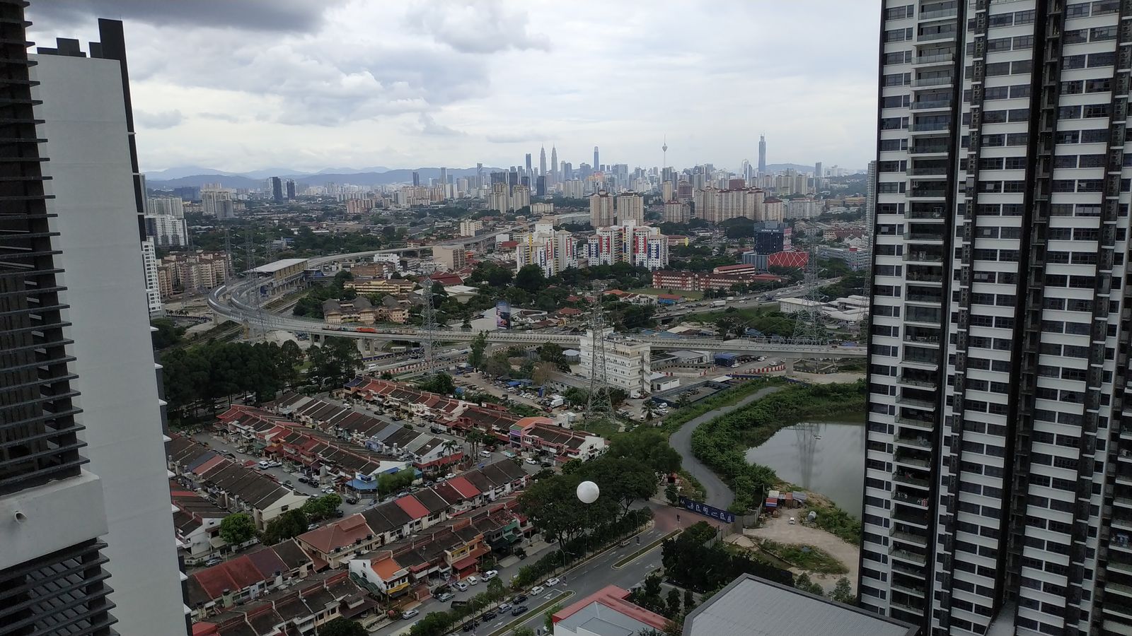 The view south from a Lakeville Residence tower: terrace houses below and the Kuala Lumpur skyline on the horizon