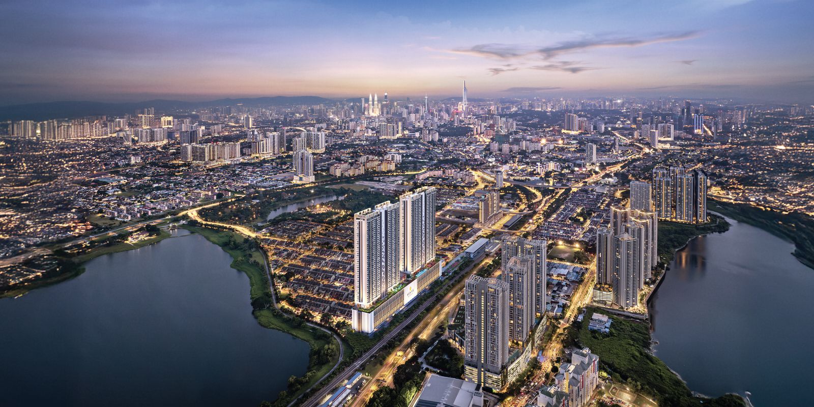 Taman Wahyu at dusk from the air: Han-Ya Wahyu's two towers beside the rail line, lakes in the foreground and the Kuala Lumpur skyline on the horizon