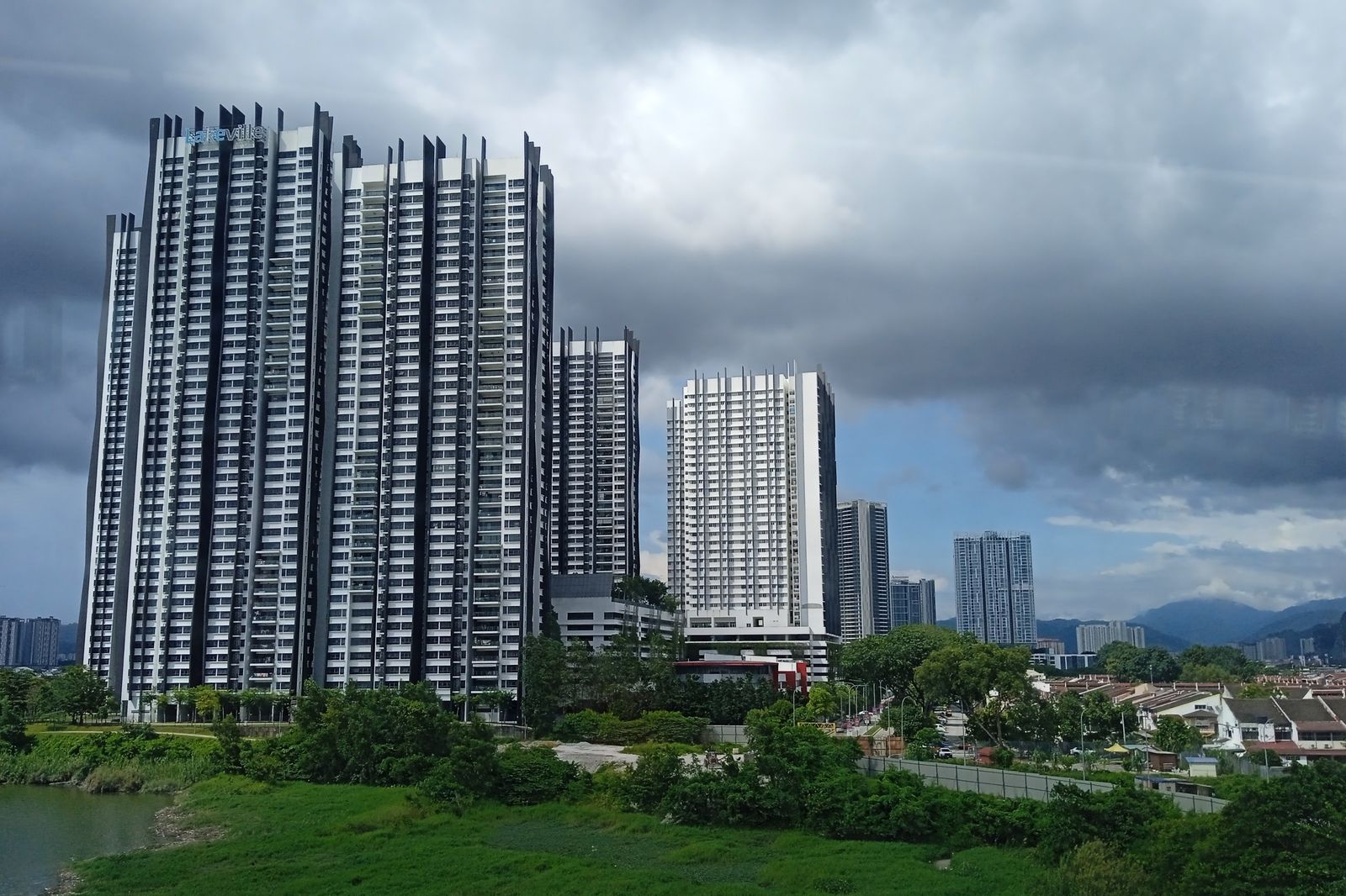 Lakeville Residence towers above the lakeshore under a stormy sky