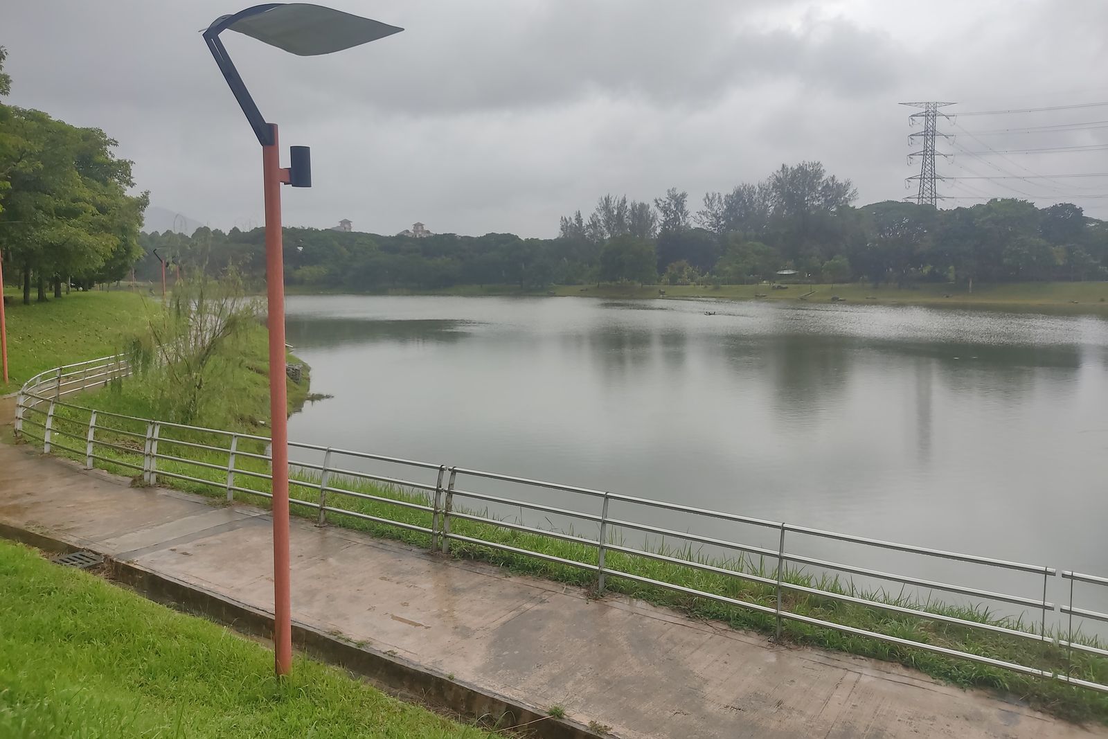 A lakeside path with railings at Batu Metropolitan Park